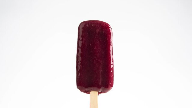 Strawberry popsicle melting time lapse motion photography 