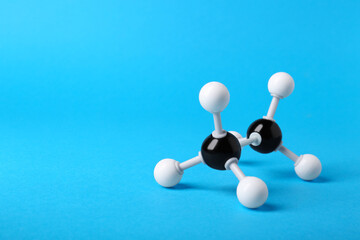 Molecule of alcohol on light blue background, space for text. Chemical model