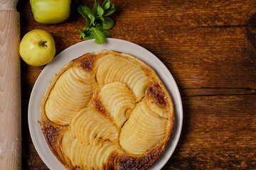 Cooked apple pie on wooden background. Finished semi-finished product. Top view. Place for text.