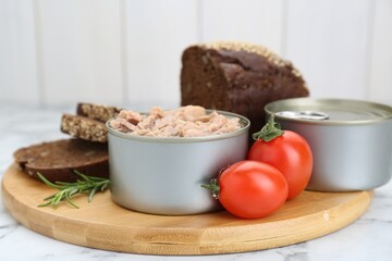 Composition with canned tuna on white marble table, closeup