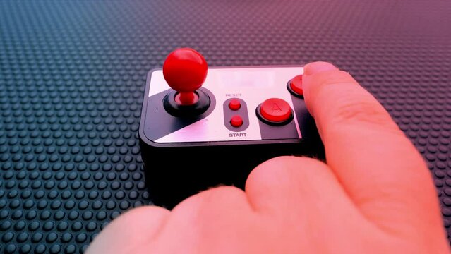 remote control on dark background, red button, finger presses red button, control start, threat of using nuclear, chemical weapons of mass destruction, concept Rocket launch at push of button