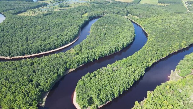 Flying over a very winding river and forest in Northern Minnesota near the border of Canada