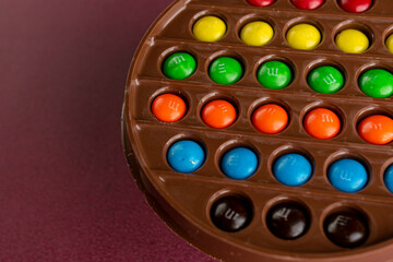Round plate of milk chocolate with colorful sprinkles - Easter