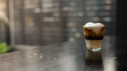Dirty Coffee - A glass of espresso shot mixed with cold fresh milk in coffee shop cafe and...