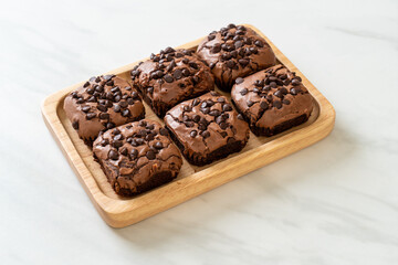 dark chocolate brownies topped by chocolate chips
