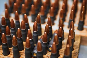 Riffle bullets in wooden racks in production plant workshop