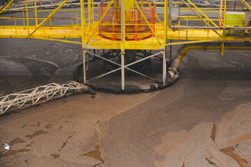 Large round floatation machine tank full of liquid at plant