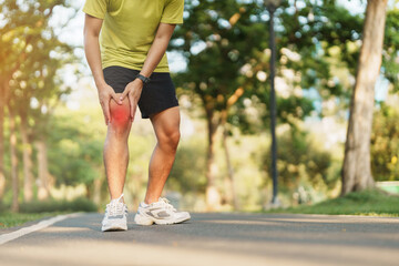 Young adult male with muscle pain during running. runner have knee ache due to Runners Knee or...