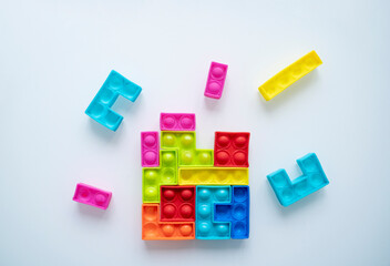 Colorful toy blocks flying around and  making one whole piece