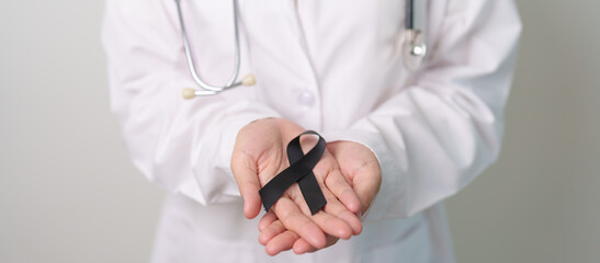 Melanoma and skin cancer, Vaccine injury awareness month and rest in peace concepts. doctor holding...