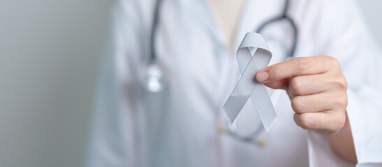 Brain Cancer Awareness May month, Doctor with grey color Ribbon for supporting life people....