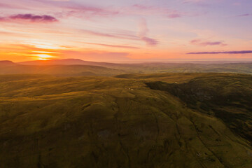 Scenic sunset view over the rolling hills of Wales showcasing vibrant colors and natural beauty during twilight hours