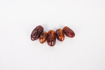 A group of brown dates are on a white background.