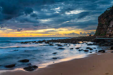 Sunrise with scattered rain clouds at the seaside