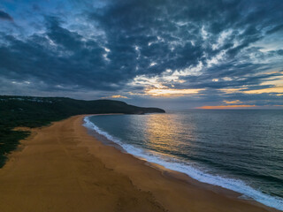 Sunrise seascape with clouds and gentle surf