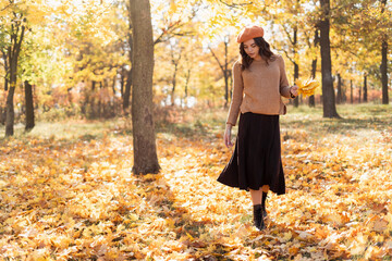 Happy young woman walking autumn park. Relaxation, enjoying, solitude with nature.