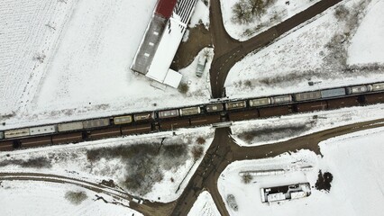 Munich, Germany Bavaria - April 02, 2022: Deutsche Bahn freight train on the railroad tracks with a road below a bridge.