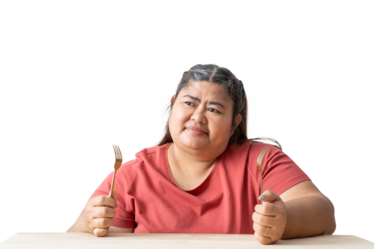 Asian Fat woman holding a spoon and fork on table isolated on white and transparent background