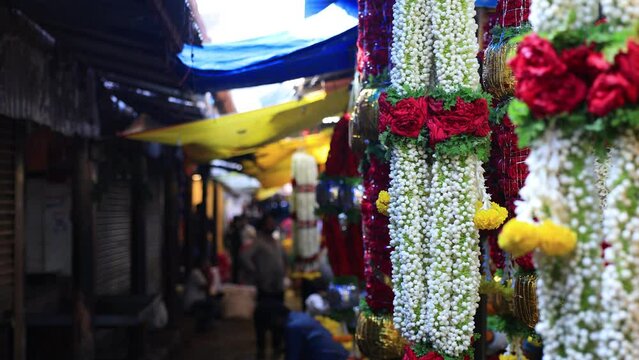Indian Wedding Garland for Sale in a Fresh Flower and Floral Market, Mysuru, Karnataka, India. Beautiful bright flowers garland made of Mysuru Mallige (Jasminum Grandiflorum) and Red Roses.