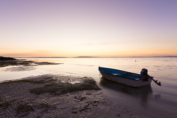 Boat on the beach during calm sunset in South Australia