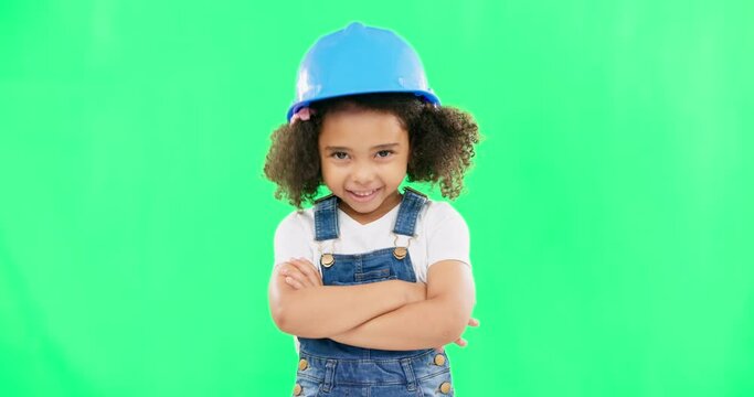 Little girl, face and smile in construction on green screen with safety helmet and arms crossed against a studio background. Portrait of small and happy child architect smiling on chromakey mockup