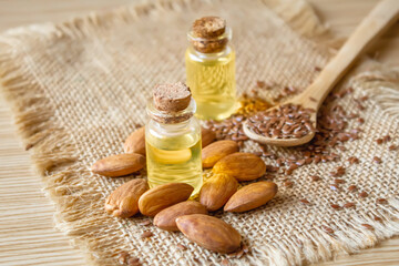 Fototapeta na wymiar Almond essential oil in a small bottle. Selective focus.
