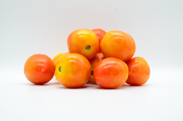 Pile of tomatoes on white background