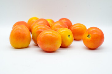 Pile of tomatoes on white background