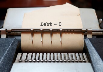 Old vintage classic calculator with text on paper DEBT = 0, concept of financial planning , set...