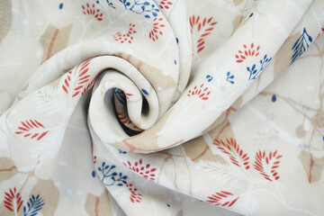 wavy and folded fabric patterned with leaves