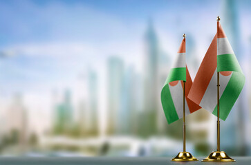 Small flags of the Niger on an abstract blurry background