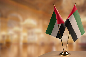 Small flags of the Arab Emirates on an abstract blurry background