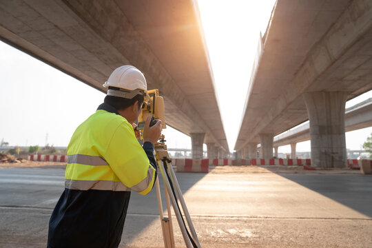 Surveyor engineer worker making measuring with theodolite on road works.survey engineer in construction site