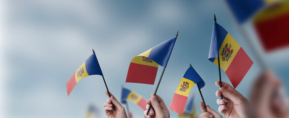 A group of people holding small flags of the Moldavia in their hands