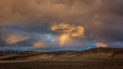 Fototapeta na wymiar Rainbow and dramatic cloud and mountain in the Iceland