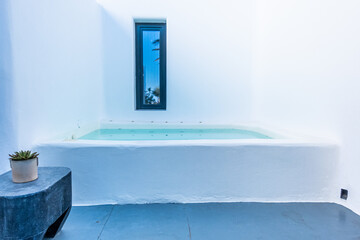 Small tub in a white concrete room in Greece