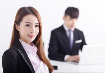 Fototapeta premium Successful business woman sitting with her staff in background at office