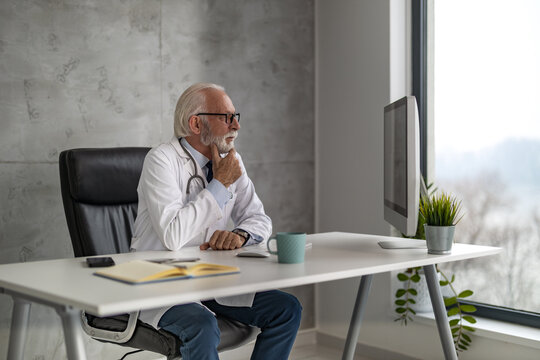 Shot of senior male doctor working online consultation