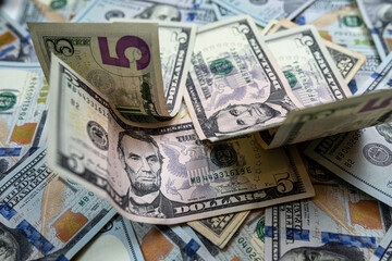 1 2 5 10 100 Different dollar bills in a pile as background