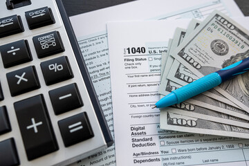 2022 blank tax form with money cash pen and calculator