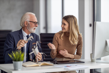 Senior engineer and technician working together on new project in modern office