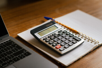 counting bills, accountant table with glasses, calculator and notebook with pencil