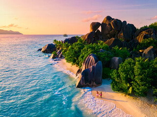 Anse Source d'Argent, La Digue Seychelles, a young couple of men and women on a tropical beach...