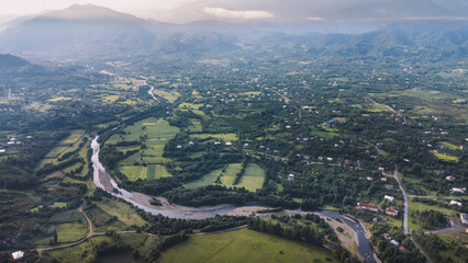 Green village and river in summer