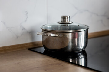 Metal pot on induction cooker.