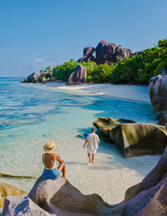 Anse Source d'Argent beach, La Digue Island, Seychelles, couple men and woman walking at the beach...