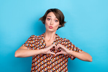 Photo of lovely cute girl pouted lips kiss arms fingers make show heart symbol isolated on blue color background