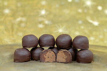 chocolate candies on golden background