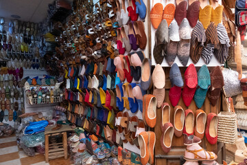 Colorful leather and fabric babouches for sale in a souk in the Medina in Marrakesh Morocco