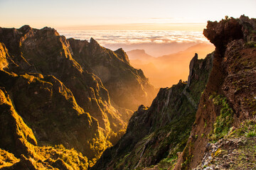 Beautiful sunrise in Madeira highest mountains range. Hiking trial from Pico do Areerio to Pico do...